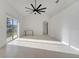 A very spacious living room with tiled flooring and a large sliding glass door at 10955 Lemay Dr, Clermont, FL 34711