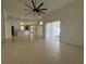 Spacious living room features tile floors and an open floor plan to the kitchen at 10955 Lemay Dr, Clermont, FL 34711