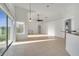 Spacious living room with high ceilings, tile floors, and sliding doors to backyard at 10955 Lemay Dr, Clermont, FL 34711
