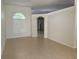 Bright living room with tile flooring, neutral walls, and arched doorway at 10955 Lemay Dr, Clermont, FL 34711