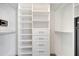 Bright walk-in closet features built-in shelving and drawers at 10955 Lemay Dr, Clermont, FL 34711