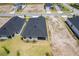 An aerial view showcases the new home's roof, patio, and landscaping at 1257 Champions Dr, Daytona Beach, FL 32124