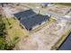 An aerial view highlights the new construction's roof, patio, and landscaping on a spacious lot at 1257 Champions Dr, Daytona Beach, FL 32124