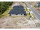An aerial view of the new home highlights the roof and landscaping on a well-sized lot in the community at 1257 Champions Dr, Daytona Beach, FL 32124