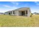 A spacious backyard and covered patio enhance outdoor enjoyment and provide extra living space at 1257 Champions Dr, Daytona Beach, FL 32124