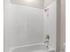Bathroom featuring a bathtub, shower with gold fixtures, and white tile at 1257 Champions Dr, Daytona Beach, FL 32124