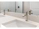 Bathroom vanity with dual sinks, modern faucets, and quartz countertops reflected in a large mirror at 1257 Champions Dr, Daytona Beach, FL 32124