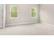 Inviting bedroom with plush carpeting and ample natural light from two windows at 1257 Champions Dr, Daytona Beach, FL 32124