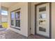 Welcoming entryway featuring a modern front door, sidelight windows, and stone-accented columns at 1257 Champions Dr, Daytona Beach, FL 32124