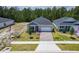 Beautiful single-story home showcasing a paved driveway, manicured lawn, and attached two-car garage at 1257 Champions Dr, Daytona Beach, FL 32124
