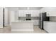 Modern kitchen featuring stainless steel appliances, a center island, and white cabinets at 1257 Champions Dr, Daytona Beach, FL 32124
