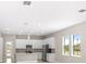 Kitchen with white cabinets, stainless steel appliances, and a center island for easy cooking at 1257 Champions Dr, Daytona Beach, FL 32124