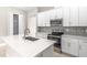 Modern kitchen boasts stainless appliances, white cabinets, and an island with a sink at 1257 Champions Dr, Daytona Beach, FL 32124