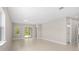 Spacious living area with neutral tile flooring, large windows, and access to the backyard at 1257 Champions Dr, Daytona Beach, FL 32124