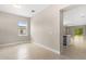 Bright, open-concept living space with tile floors and natural light from a large window at 1257 Champions Dr, Daytona Beach, FL 32124