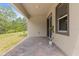 Covered brick patio offers a comfortable outdoor living area with sliding door access to the home at 1257 Champions Dr, Daytona Beach, FL 32124