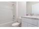 Neat bathroom features a shower over tub combination, single sink vanity, and modern fixtures at 1267 Berry Ln, Davenport, FL 33837