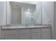 Clean bathroom features double sinks, granite countertops and a large mirror at 1267 Berry Ln, Davenport, FL 33837
