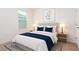 Inviting bedroom showcasing a cozy bed with blue accents, and a soothing ambiance enhanced by natural light at 1267 Berry Ln, Davenport, FL 33837