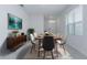 Bright dining room with modern table and chairs, neutral walls, and a large window that provides natural light at 1267 Berry Ln, Davenport, FL 33837