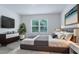 Serene bedroom featuring a large window, a flat-screen TV, and a bed with crisp, neutral bedding at 1267 Berry Ln, Davenport, FL 33837
