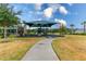 A colorful community playground with slides, climbing structures, and a shaded picnic area on a sunny day at 1267 Berry Ln, Davenport, FL 33837