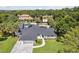 Stunning aerial view of a home featuring a dark roof and lush landscaping at 1327 Bridgeport Dr, Winter Park, FL 32789