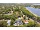 Aerial view of neighborhood with lake views, lush greenery and several estates with pools at 1327 Bridgeport Dr, Winter Park, FL 32789