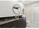 Charming bathroom featuring a vanity with dark quartz counters, shiplap accent wall, and round mirrors at 1327 Bridgeport Dr, Winter Park, FL 32789