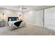 Inviting bedroom showcasing a textured accent wall, a ceiling fan, and a sliding barn door to an ensuite bathroom at 1327 Bridgeport Dr, Winter Park, FL 32789