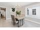 Light-filled dining room with a decorative wreath and modern chandelier, creating a warm and inviting space at 1327 Bridgeport Dr, Winter Park, FL 32789