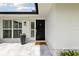 Stylish front entrance with a modern black door and 'Home Sweet Home' welcome mat at 1327 Bridgeport Dr, Winter Park, FL 32789