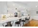 Spacious kitchen with white cabinets, stainless steel appliances, large island with seating, and modern lighting at 1327 Bridgeport Dr, Winter Park, FL 32789
