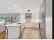 Contemporary kitchen with sleek white cabinets, stainless steel appliances, and a breakfast bar area at 1327 Bridgeport Dr, Winter Park, FL 32789