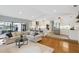 Open living room showing a modern kitchen with stainless steel appliances and a seamless transition to the outdoor space at 1327 Bridgeport Dr, Winter Park, FL 32789