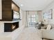 Comfortable living room featuring a brick fireplace, neutral tones, and ample natural light at 1327 Bridgeport Dr, Winter Park, FL 32789