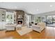 Cozy living room with fireplace, built-in shelves, and large windows for natural light with access to an outdoor patio at 1327 Bridgeport Dr, Winter Park, FL 32789