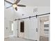 Main bedroom with barn doors leading to ensuite bathroom and walk-in closet at 1327 Bridgeport Dr, Winter Park, FL 32789