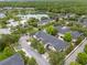Aerial view of a residential area featuring well-maintained homes, lush trees, and serene lakes at 14025 Oasis Springs Ln # 901, Windermere, FL 34786