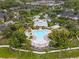 Aerial view of a community with a pool, playground, clubhouse, and landscaped surroundings at 14025 Oasis Springs Ln # 901, Windermere, FL 34786
