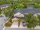 Aerial view of a beautifully landscaped two-story home with a garage and well-maintained surroundings at 14025 Oasis Springs Ln # 901, Windermere, FL 34786