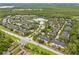 Community aerial view highlighting the neighborhood's serene setting with a lake and lush surroundings at 14025 Oasis Springs Ln # 901, Windermere, FL 34786