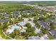 Community aerial view showcasing pool, playground, and lush landscaping at 14025 Oasis Springs Ln # 901, Windermere, FL 34786