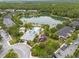 Aerial showing the community's pool, lake, playground, and well-maintained landscaping at 14025 Oasis Springs Ln # 901, Windermere, FL 34786