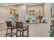 Bar area featuring raised seating, granite counters, providing a comfortable space for entertaining and socializing at 14025 Oasis Springs Ln # 901, Windermere, FL 34786