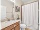Bathroom featuring granite countertops, under sink cabinet, and combined shower with tub at 14025 Oasis Springs Ln # 901, Windermere, FL 34786