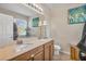 Bathroom with double sinks, granite countertop, large mirror and white cabinets at 14025 Oasis Springs Ln # 901, Windermere, FL 34786