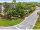 Community entrance sign reads 'Oasis Cove', surrounded by mature trees, landscaping, and a paved street at 14025 Oasis Springs Ln # 901, Windermere, FL 34786