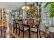 Cozy dining room featuring unique wall decor, dark hardwood floors, and a modern chandelier at 14025 Oasis Springs Ln # 901, Windermere, FL 34786