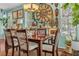 Light-filled dining room featuring modern decor, a dark wood table, and unique wall art at 14025 Oasis Springs Ln # 901, Windermere, FL 34786